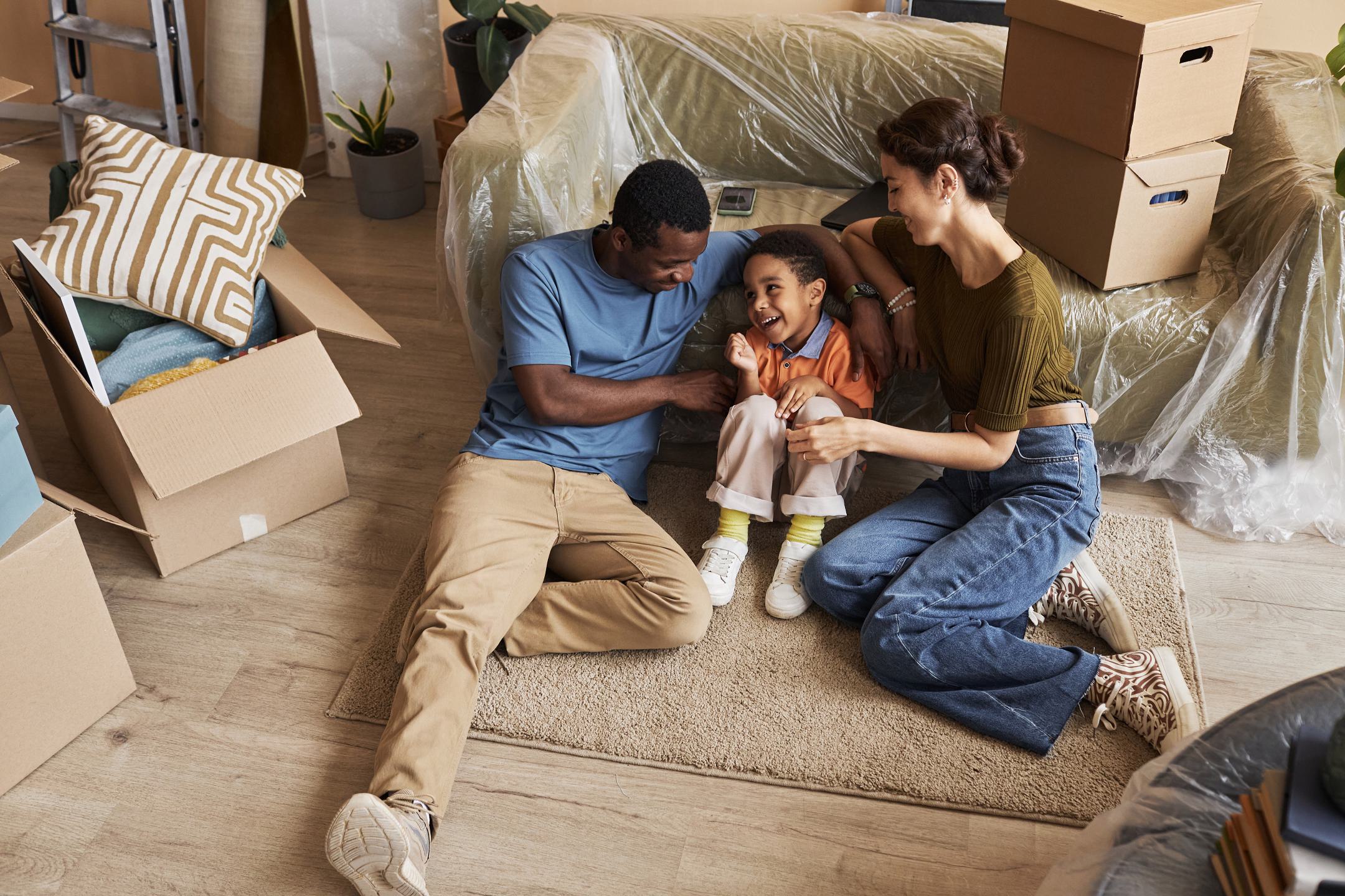 Above,Angle,Of,Young,Affectionate,Family,Sitting,On,The,Floor